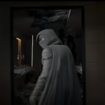 Moon Knight in full costume stares at the camera