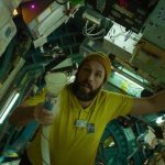 Adam Sandler floating in a spaceship