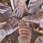 girls with lace gloves on in a circle